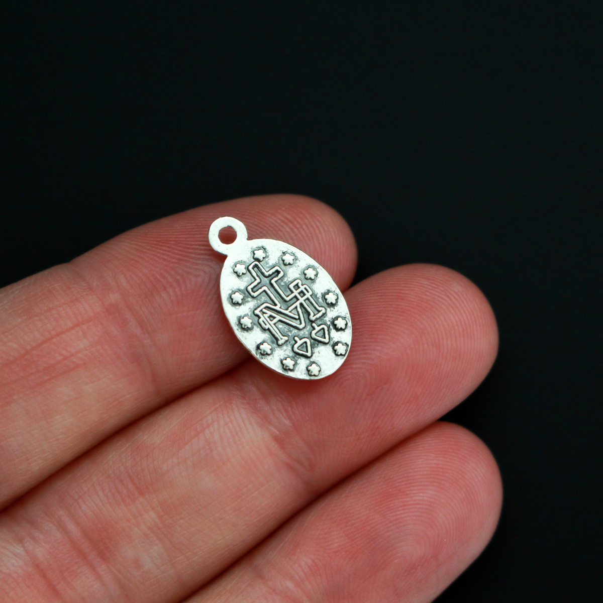 Miraculous Mary medal with the Latin inscription"O' Maria Sine Peccatis Ora Pro Nobis