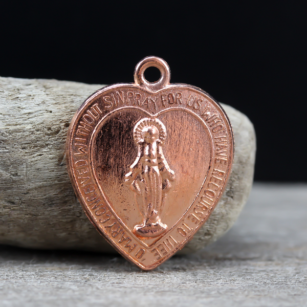 heart shaped miraculous mary medal in a rose gold color