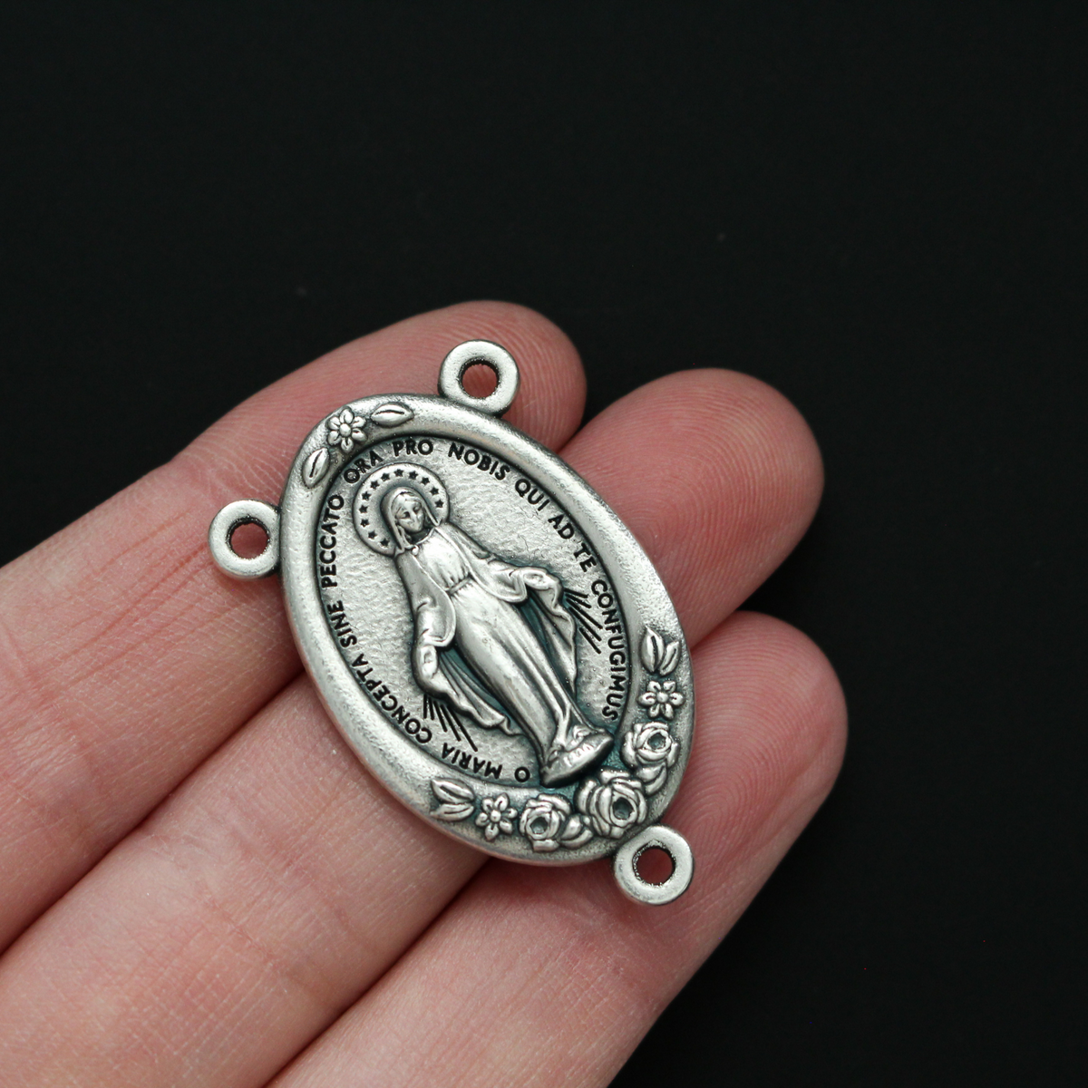Large Miraculous Mary rosary centerpiece with flower details along the edge