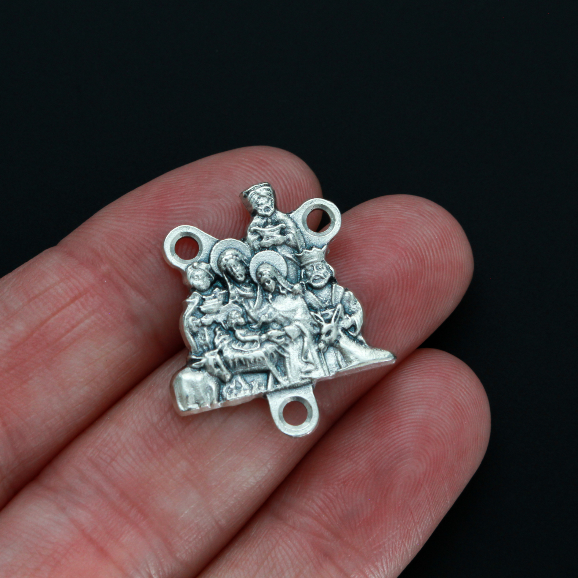Silver tone Nativity rosary centerpiece that depicts Joseph, Mary, Jesus and the three wise men