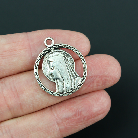 our lady of lourdes pendant with a cutout filigree design