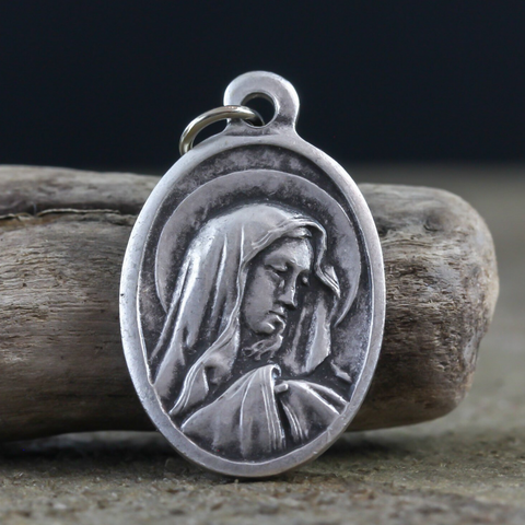 Our Lady of Sorrows die cast silver oval one inch medal