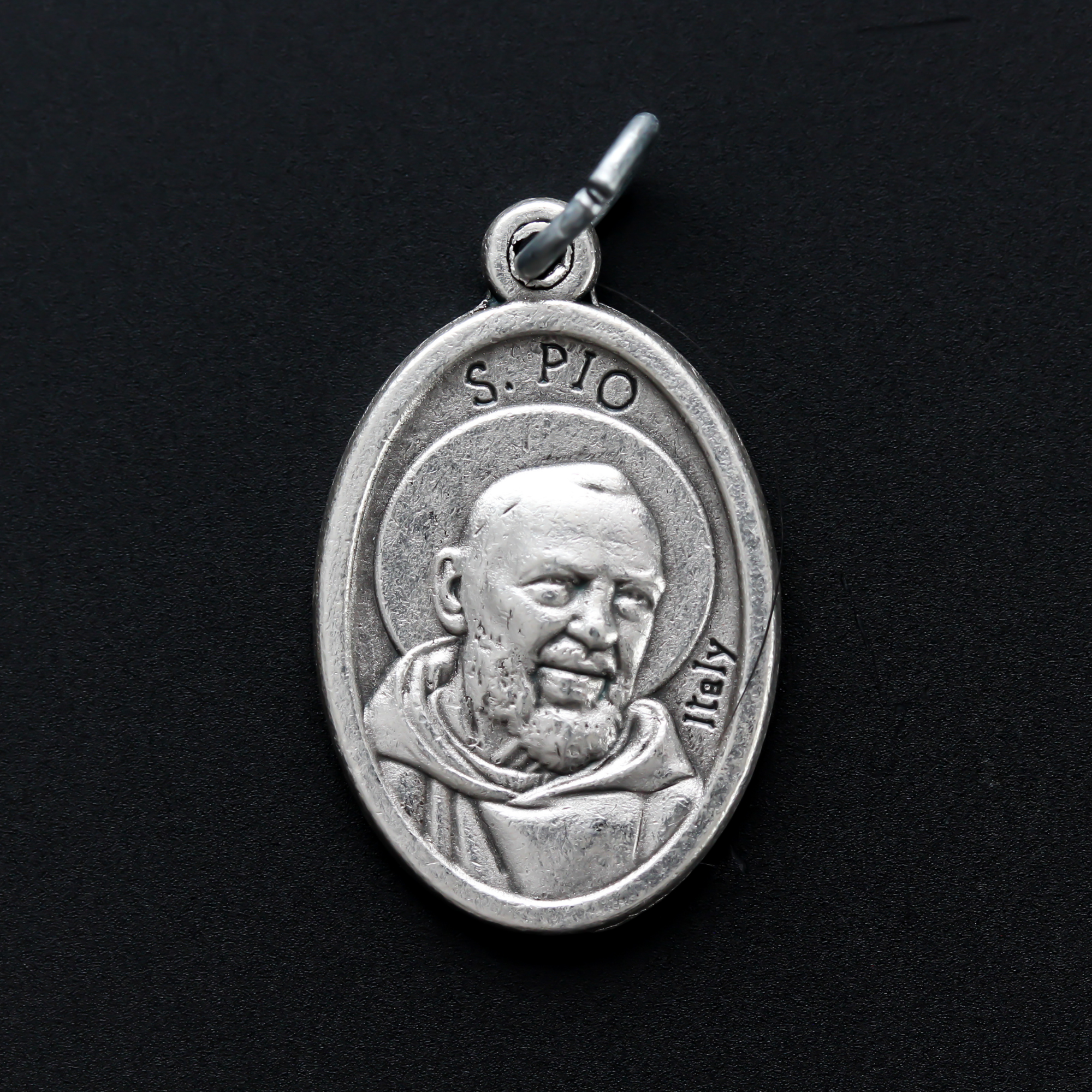 die cast silver medal depicting patron saint padre pio