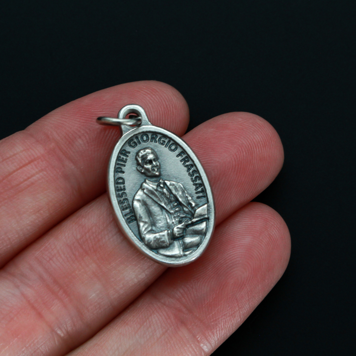 Blessed Pier Giorgio Frassati medal that depicts Pier on the front and "Pray for us" on the backside.