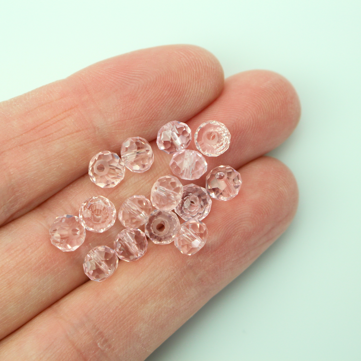 Asian cut crystal glass beads. Pink 6mm x 4.4mm faceted transparent. Sold in packages of 60 beads