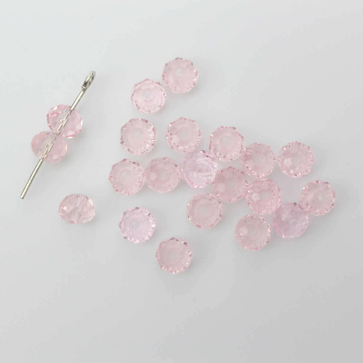 Asian cut crystal glass beads. Pink 6mm x 4.4mm faceted transparent. Sold in packages of 60 beads