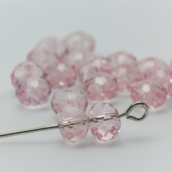 Asian cut crystal glass beads. Pink 6mm x 4.4mm faceted transparent. Sold in packages of 60 beads