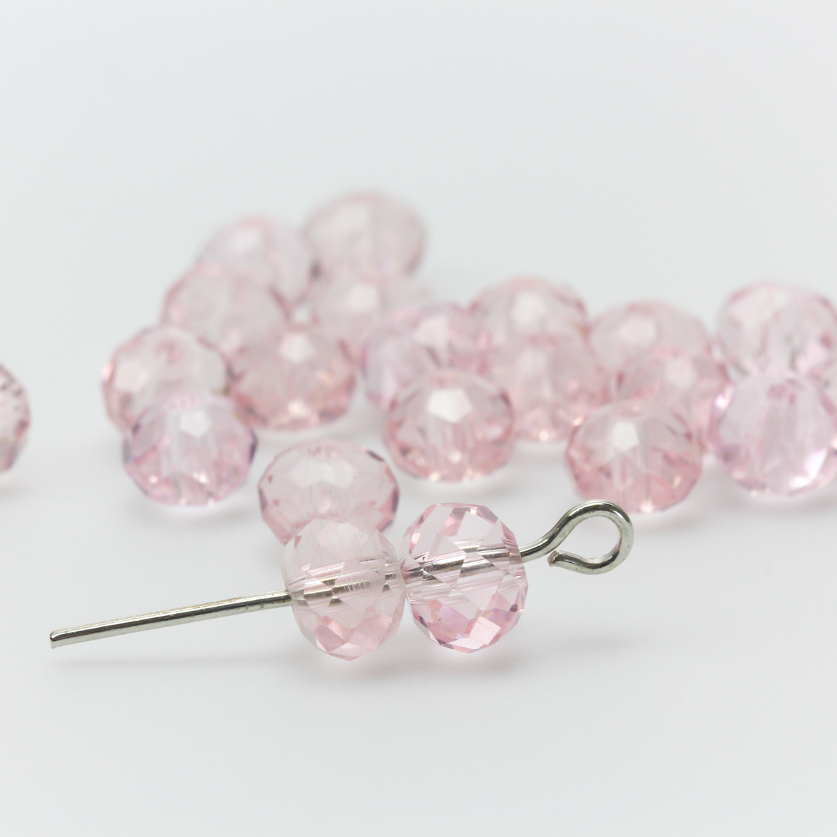 Asian cut crystal glass beads. Pink 6mm x 4.4mm faceted transparent. Sold in packages of 60 beads