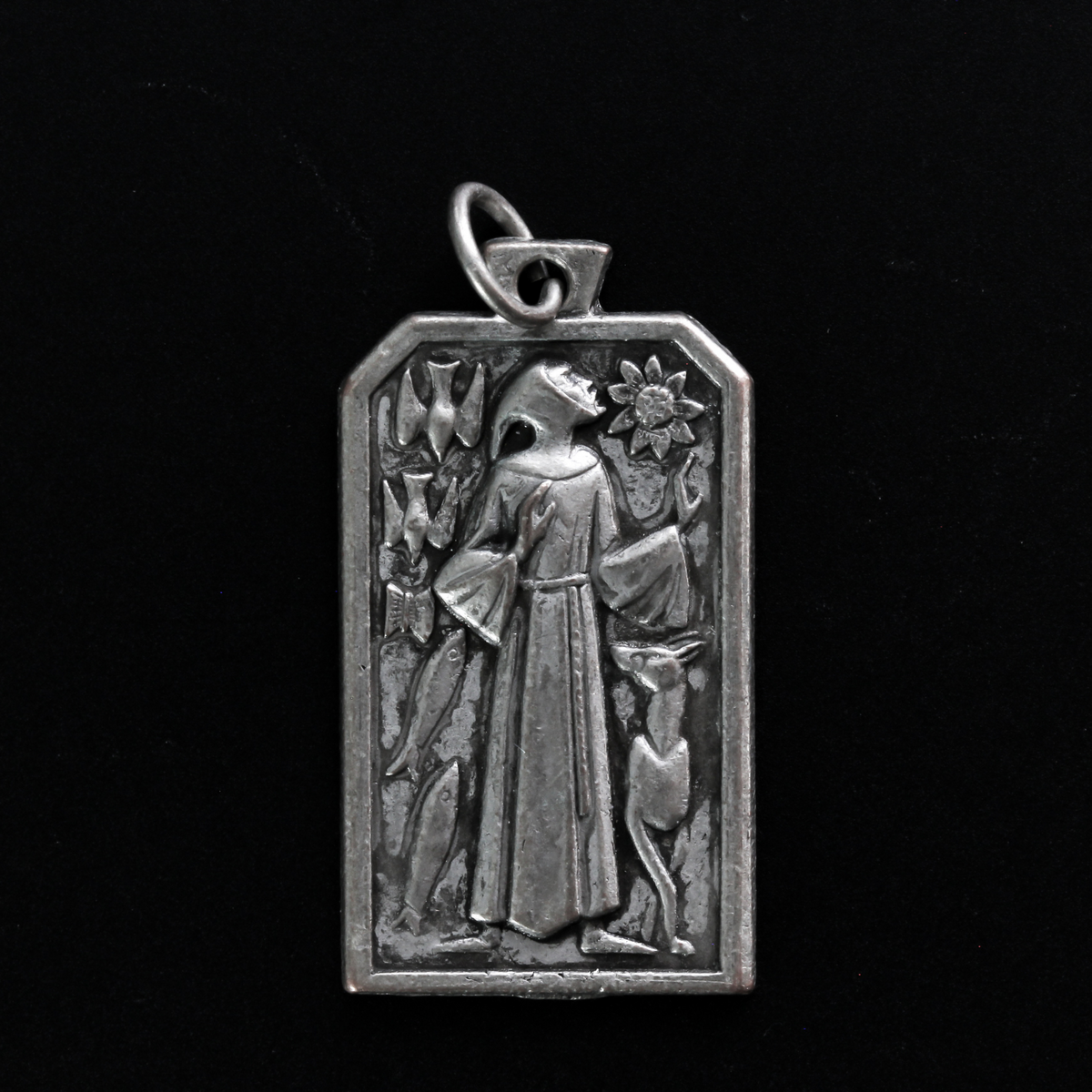 Unique rectangle-shaped pendant depicting Saint Francis surrounded by animals. Marked "Pray For Us" on the back