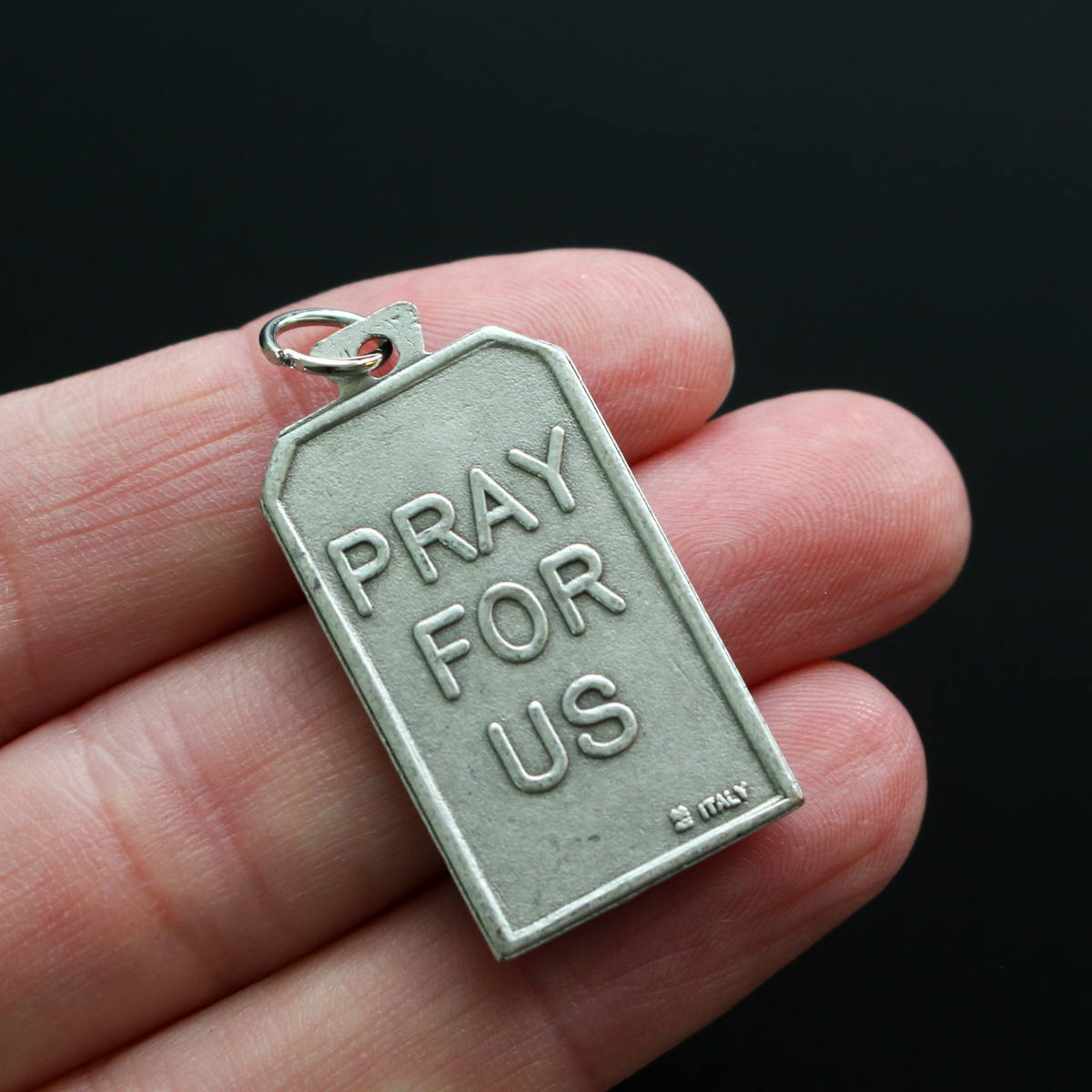 Unique rectangle-shaped pendant depicting Saint Francis surrounded by animals. Marked "Pray For Us" on the back