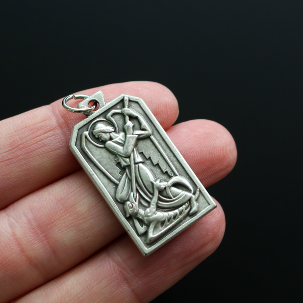 Unique rectangle-shaped pendant depicting Saint Michael defeating Satan. Marked "Pray For Us" on the back