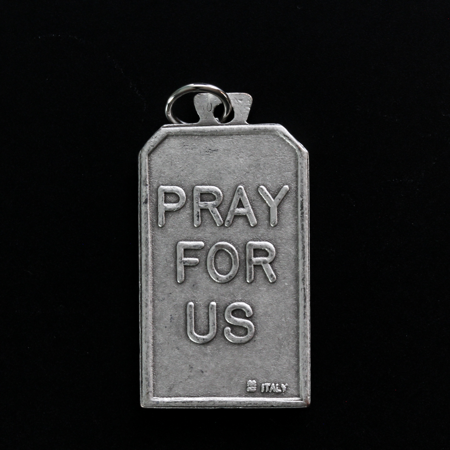 Unique rectangle-shaped pendant depicting Saint Michael defeating Satan. Marked "Pray For Us" on the back