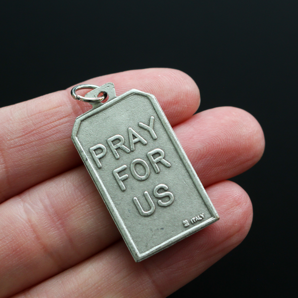 Unique rectangle-shaped pendant depicting Saint Michael defeating Satan. Marked "Pray For Us" on the back
