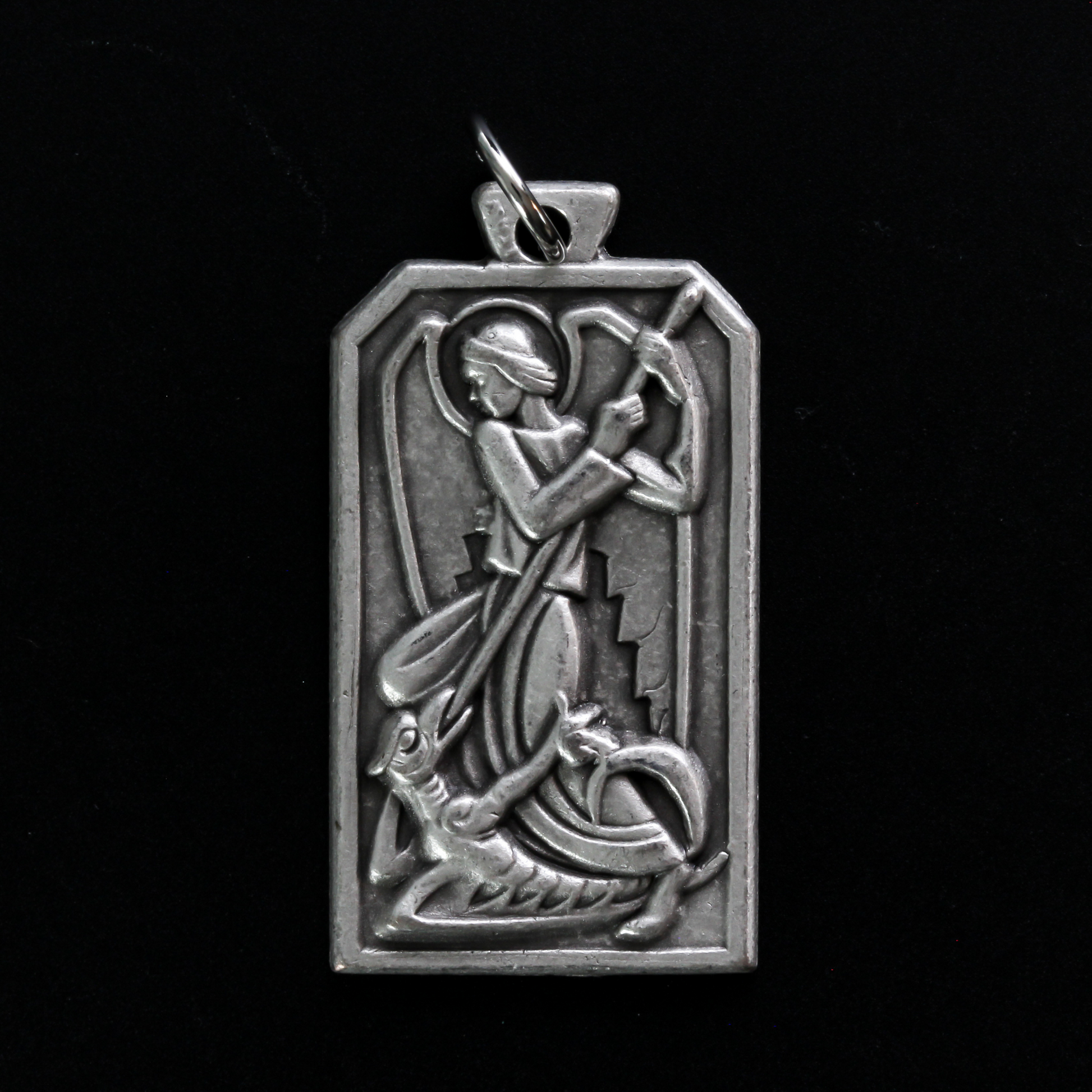 Unique rectangle-shaped pendant depicting Saint Michael defeating Satan. Marked "Pray For Us" on the back