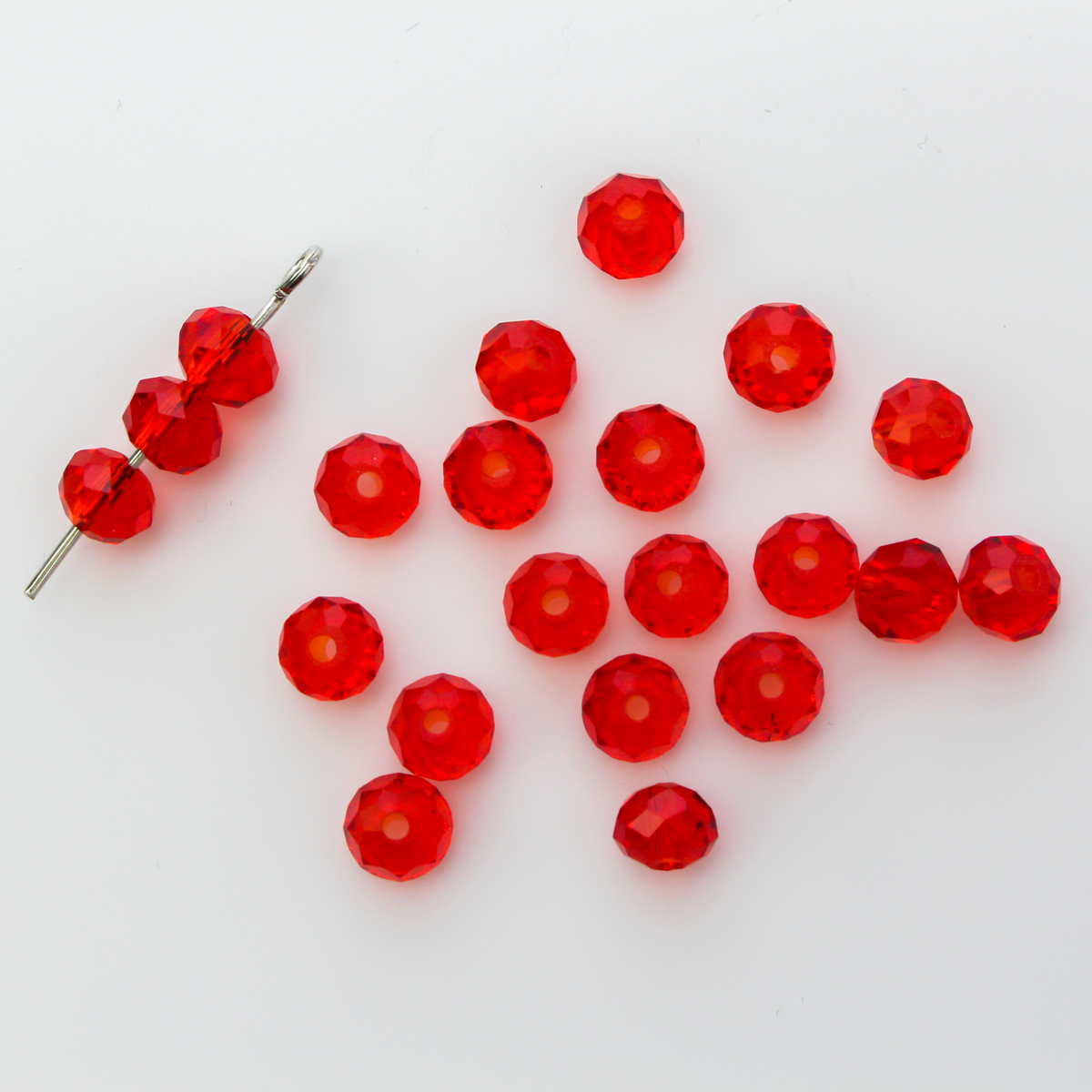 Asian cut crystal glass beads. 6mm x 4mm faceted red transparent. Sold in packages of 60 beads
