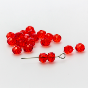 Asian cut crystal glass beads. 6mm x 4mm faceted red transparent. Sold in packages of 60 beads