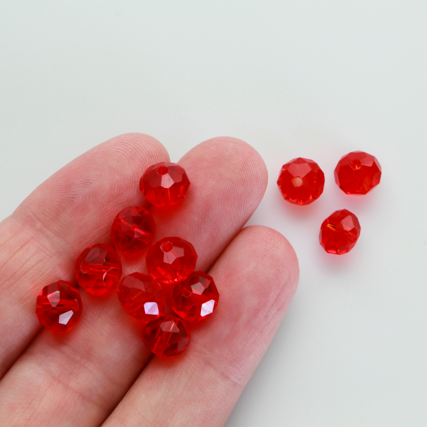 Asian cut crystal glass beads. 8mm x 6.2mm rondelle faceted red transparent. Sold in packages of 60 beads