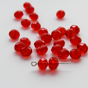 Asian cut crystal glass beads. 8mm x 6.2mm rondelle faceted red transparent. Sold in packages of 60 beads