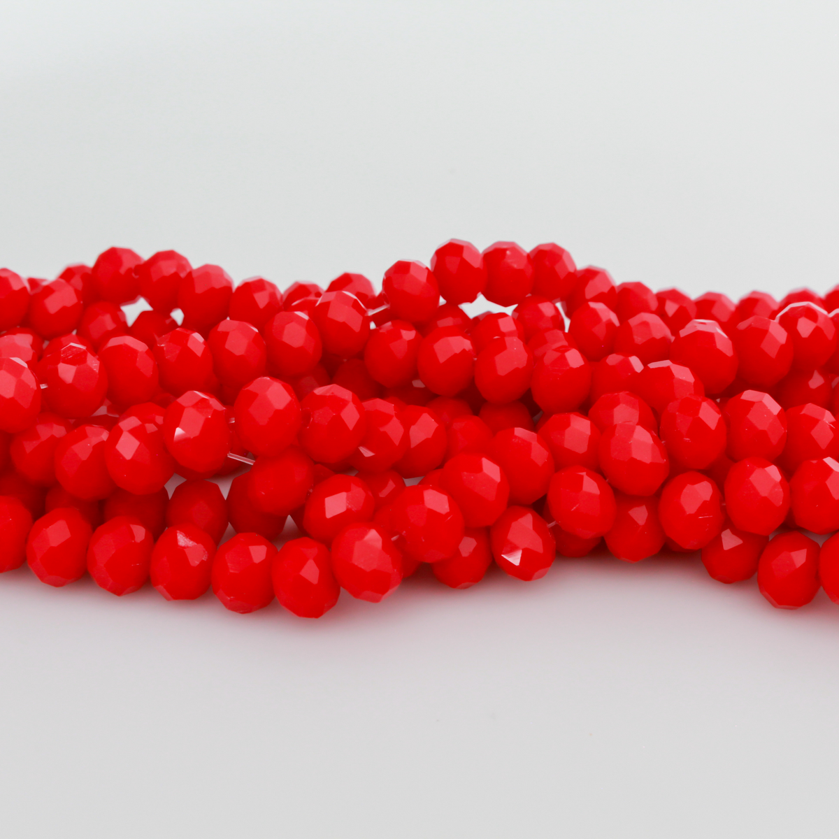 Glass faceted rondelle beads in an fire brick red color.