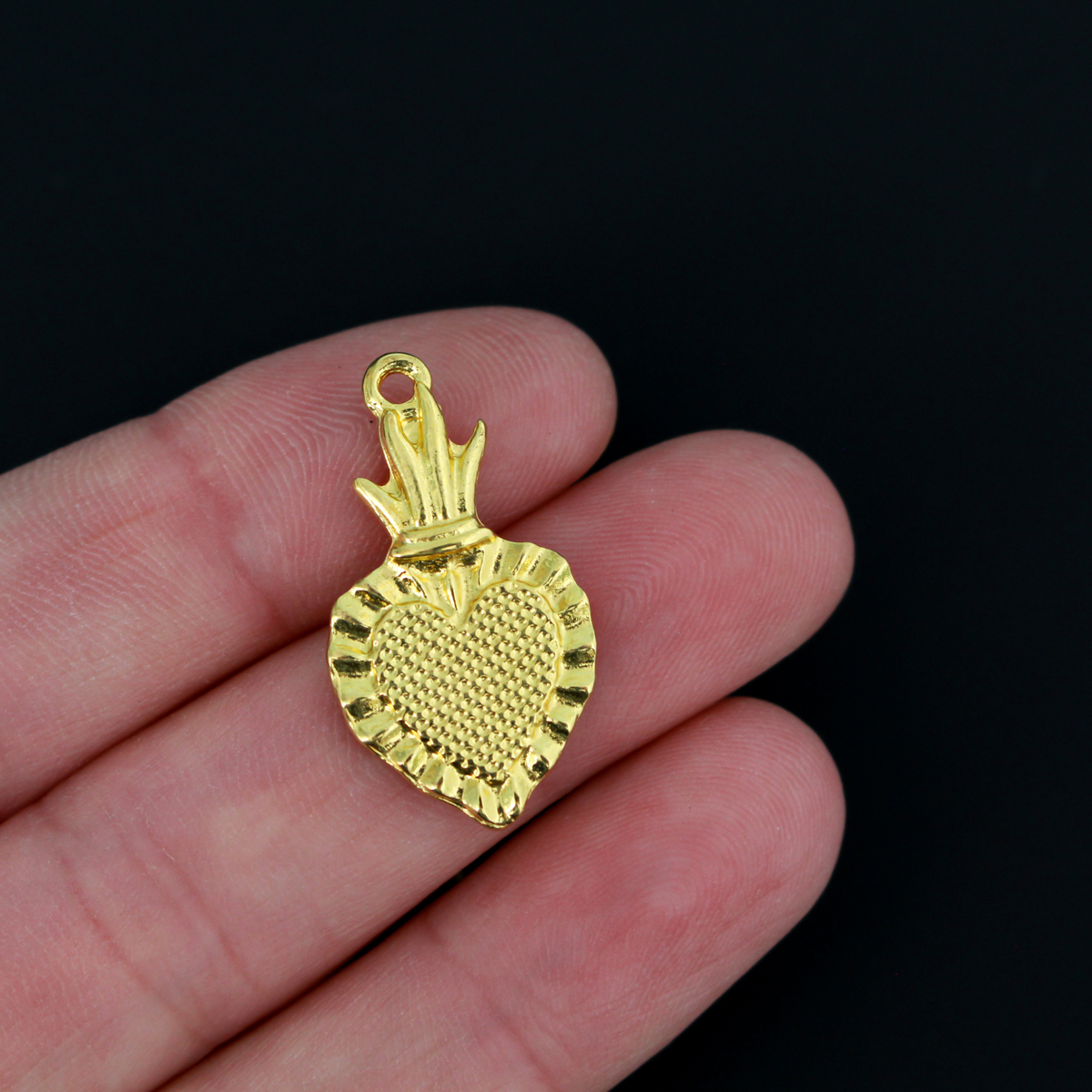 Sacred Heart Ex Voto charms that are a shiny gold color with red enamel detail.