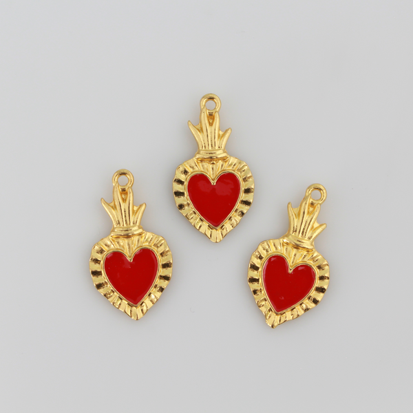 Sacred Heart Ex Voto charms that are a shiny gold color with red enamel detail.