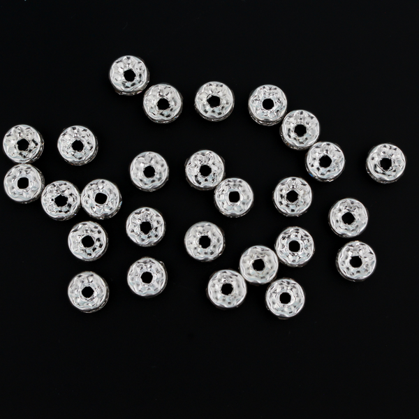 Rhinestone spacer beads that are 8mm in diameter. The bead is brass with a silver plating and the rhinestones are grade A.