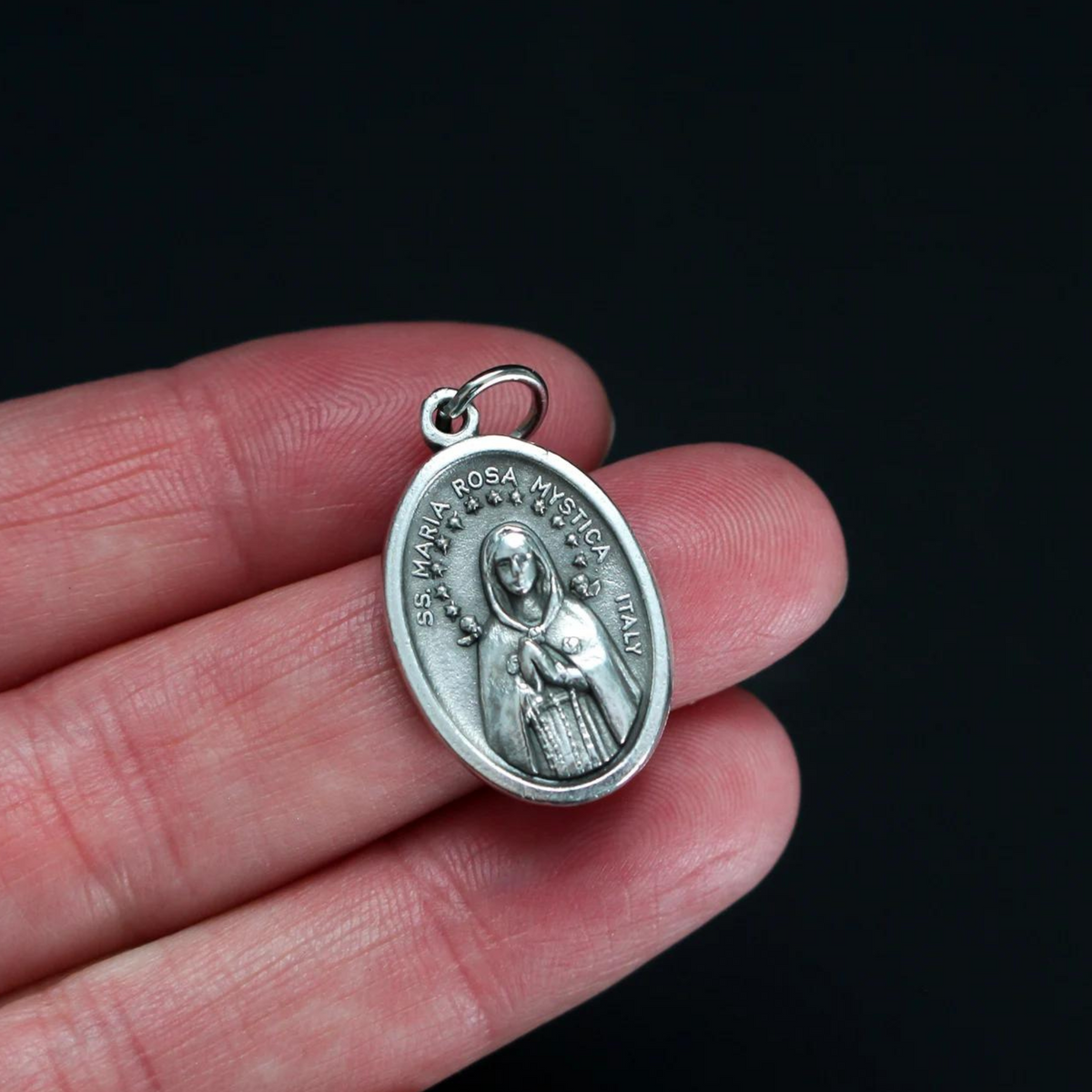 Maria Rosa Mystica medal that is marked "Pray for us" on the backside