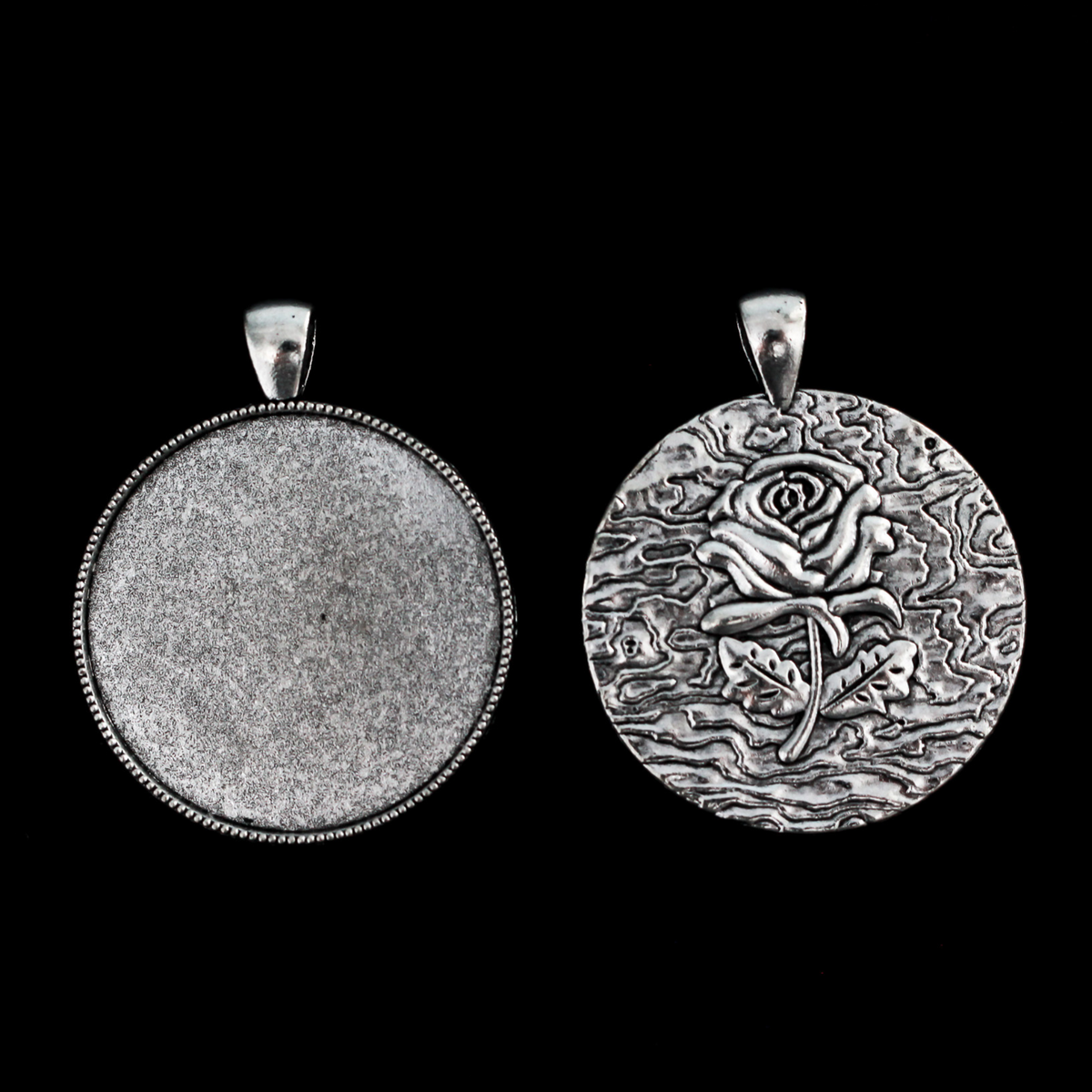 Three silver cabochon settings with a detailed rose on the backside. The tray fits 35mm cabochons which are included