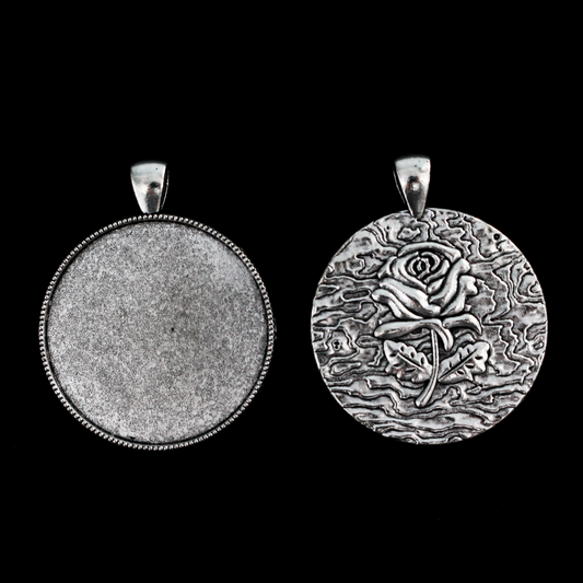 Three silver cabochon settings with a detailed rose on the backside. The tray fits 35mm cabochons which are included