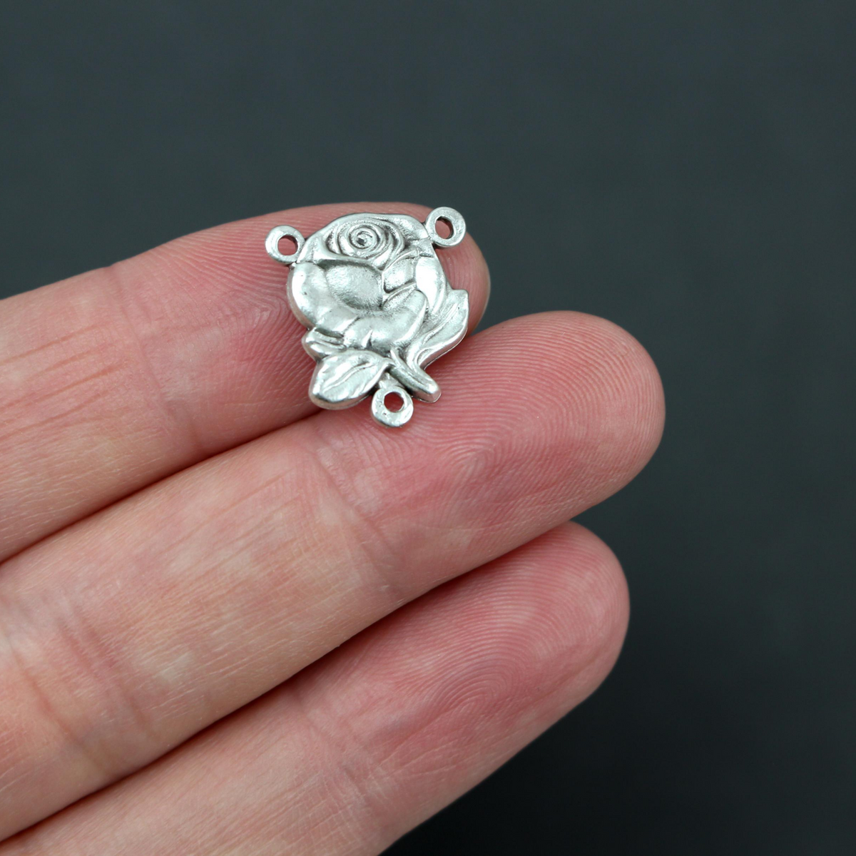 rose shaped rosary centerpiece with our lady of grace on the back