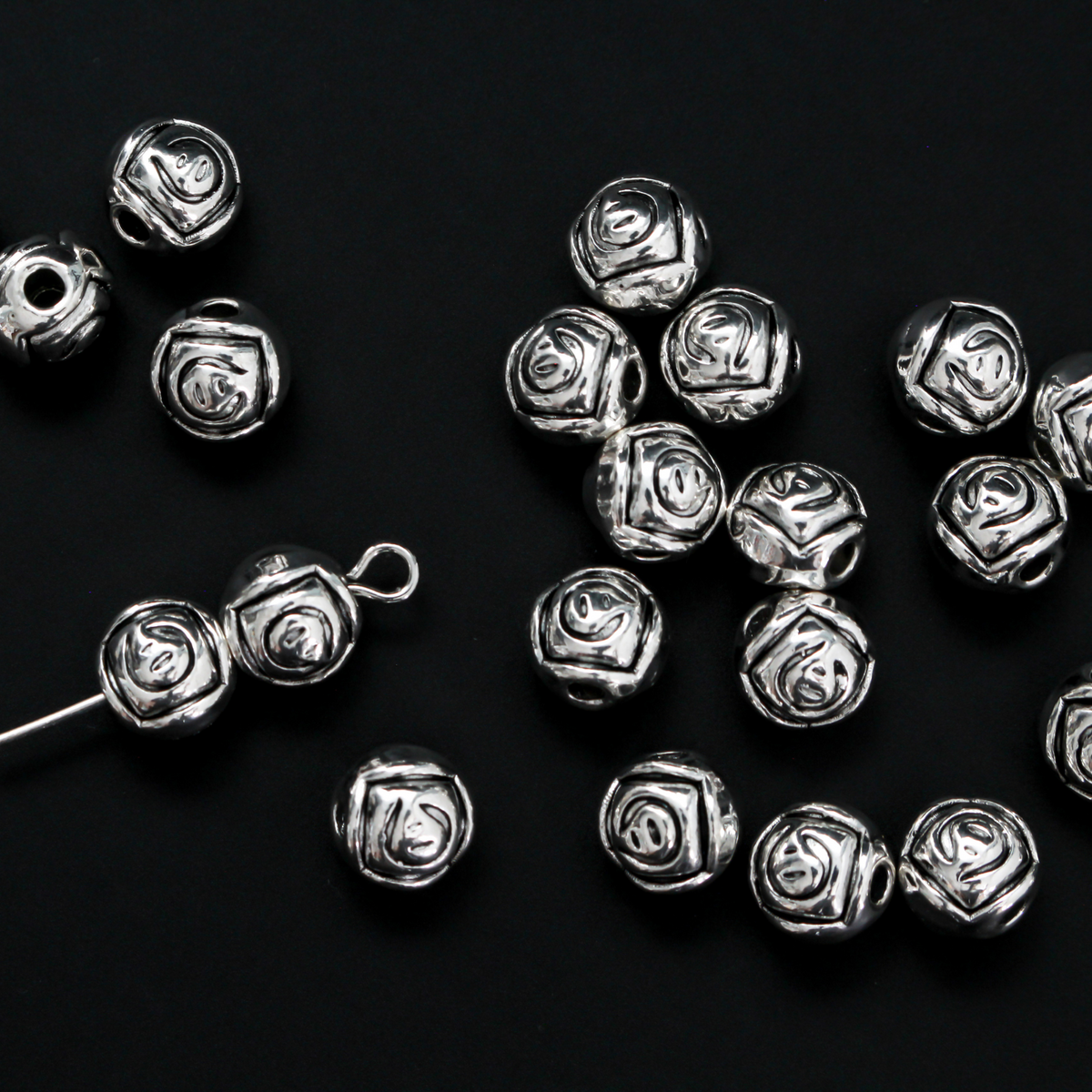 Antiqued silver-tone metal beads with a rosebud pattern 6.6mm in diameter, 60 beads total.