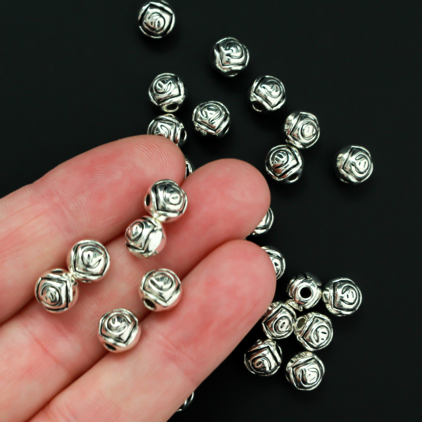 Antiqued silver-tone metal beads with a rosebud pattern 6.6mm in diameter, 60 beads total.