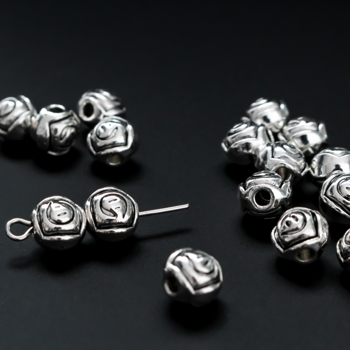 Antiqued silver-tone metal beads with a rosebud pattern 6.6mm in diameter, 60 beads total.