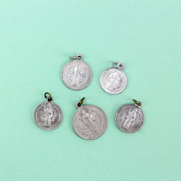 five vintage saint benedict medals in varying sizes and condition
