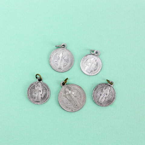 five vintage saint benedict medals in varying sizes and condition