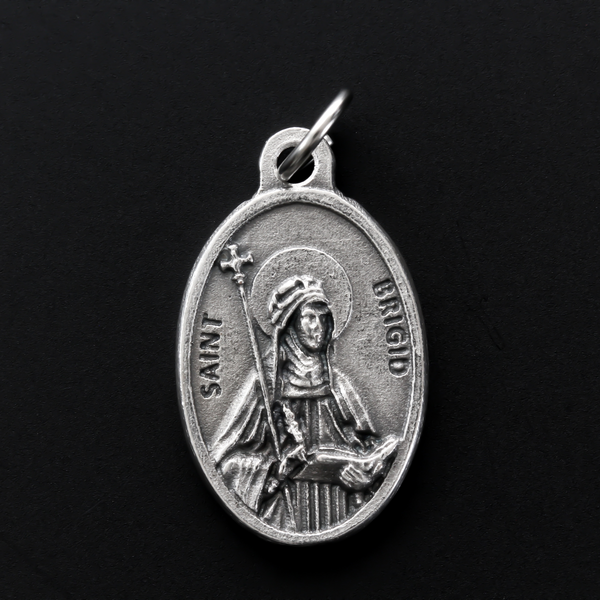 Saint Brigid of Kildare oval medal that depicts the saint on the front and "Pray For Us" on the back.