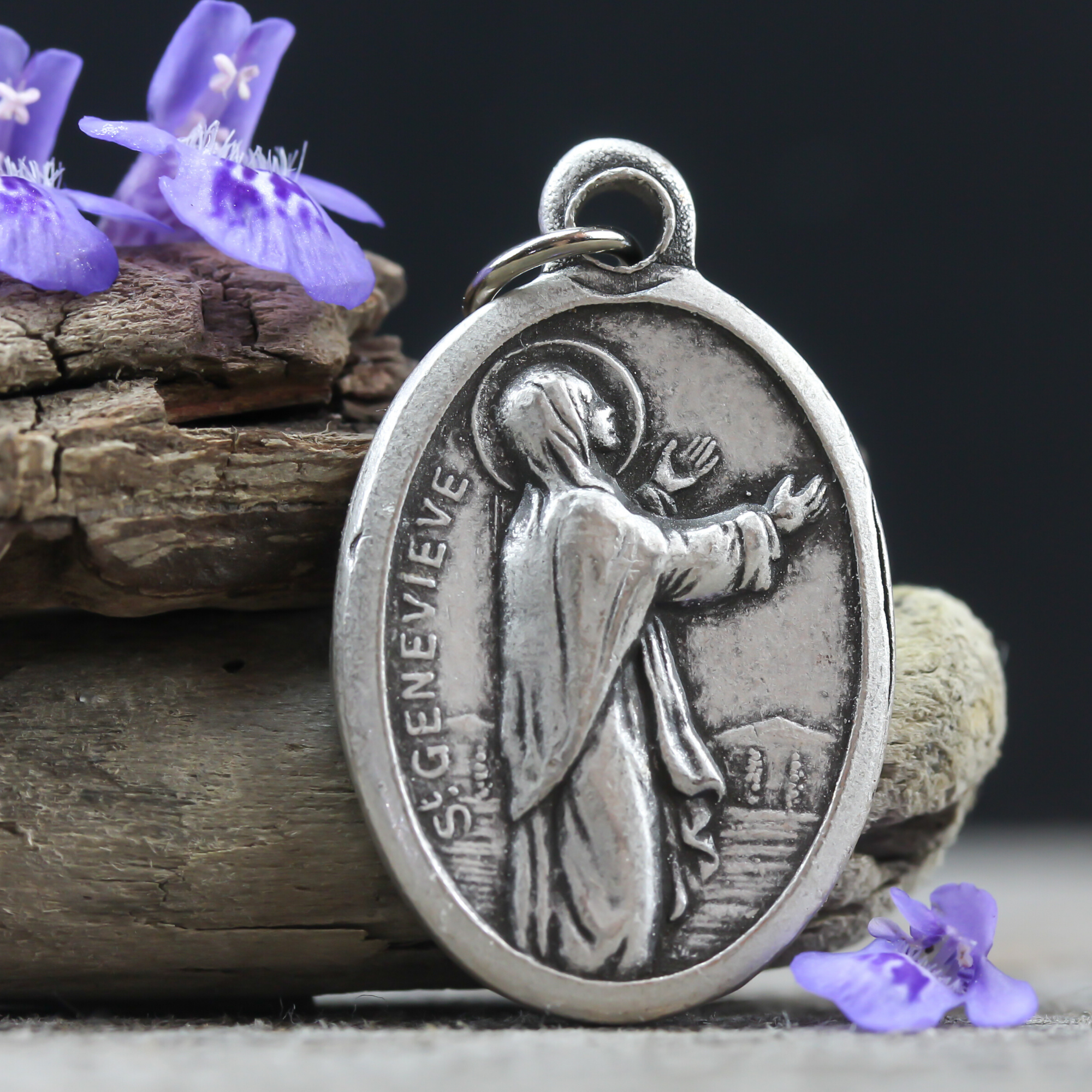 die cast silver tone medal depicting Saint Genevieve