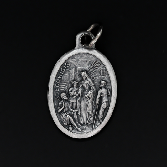 Saint Hedwig of Silesia medal, also known as Hedwig of Andechs. This medals depicts the saint on the front helping the poor. Her name is written in the Spanish translation: Santa Eduvigis. The reverse side of the medal is marked "Pray for us"