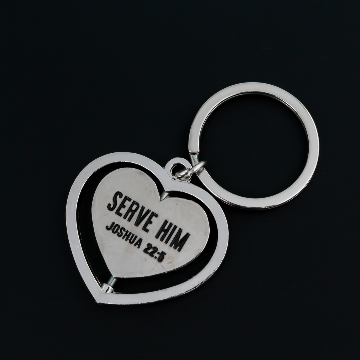 Serve with a heart like Jesus spinner key ring. The heart spins in a circle and both sides of the heart are engraved with "Serve Him Joshua 22:5".