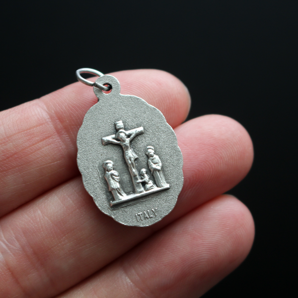 Our Lady of the Seven Sorrows medal that depicts the Virgin Mary on the front, her heart is pierced by seven swords which represent the seven sorrows.