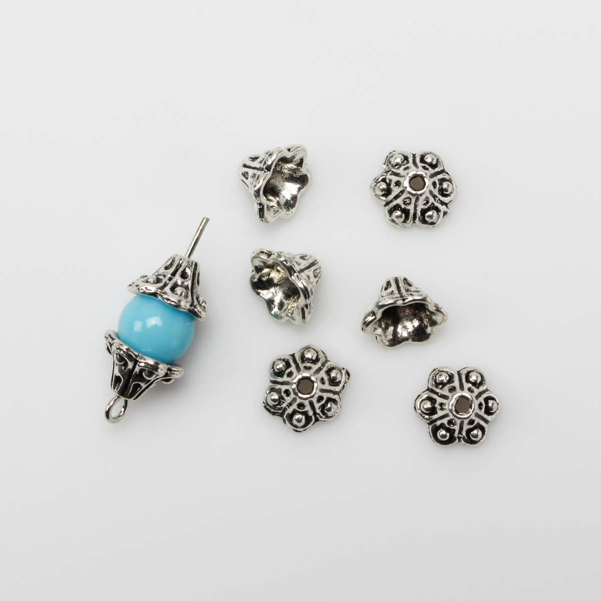 Bell flower shaped bead caps that will fit beads 8mm - 10mm. Shown on an 8mm glass bead for size reference. Sold in packages of 50 caps