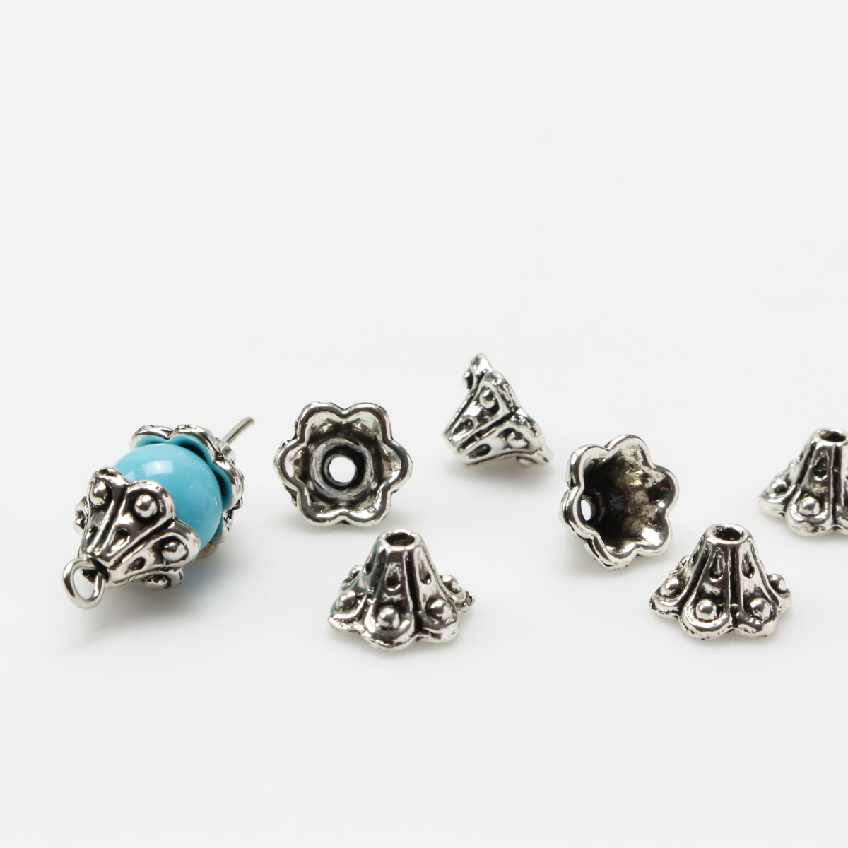 Bell flower shaped bead caps that will fit beads 8mm - 10mm. Shown on an 8mm glass bead for size reference. Sold in packages of 50 caps
