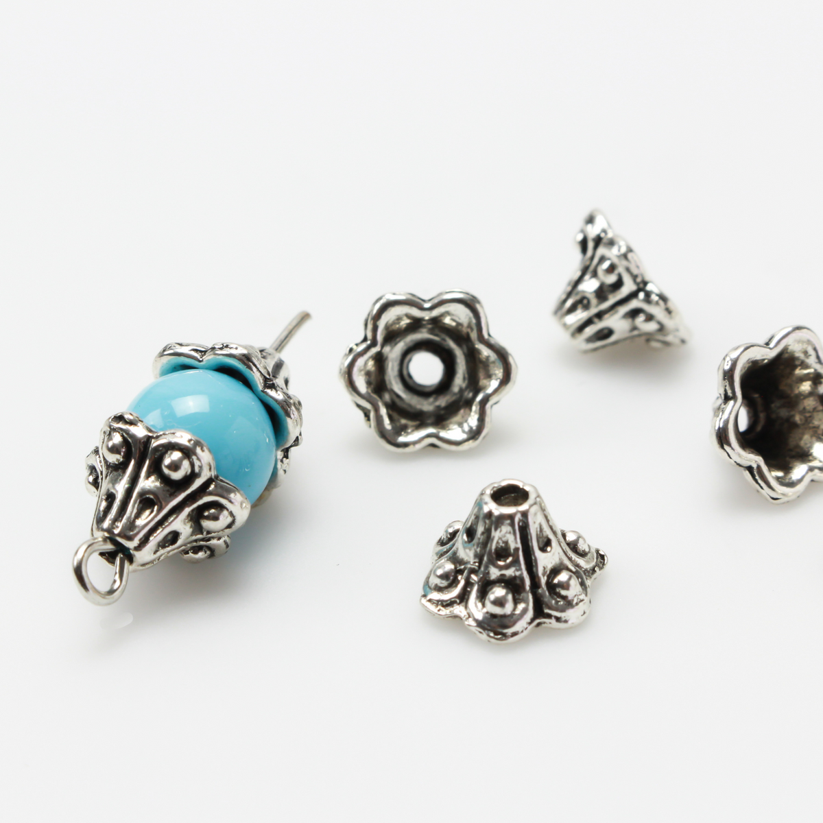 Bell flower shaped bead caps that will fit beads 8mm - 10mm. Shown on an 8mm glass bead for size reference. Sold in packages of 50 caps