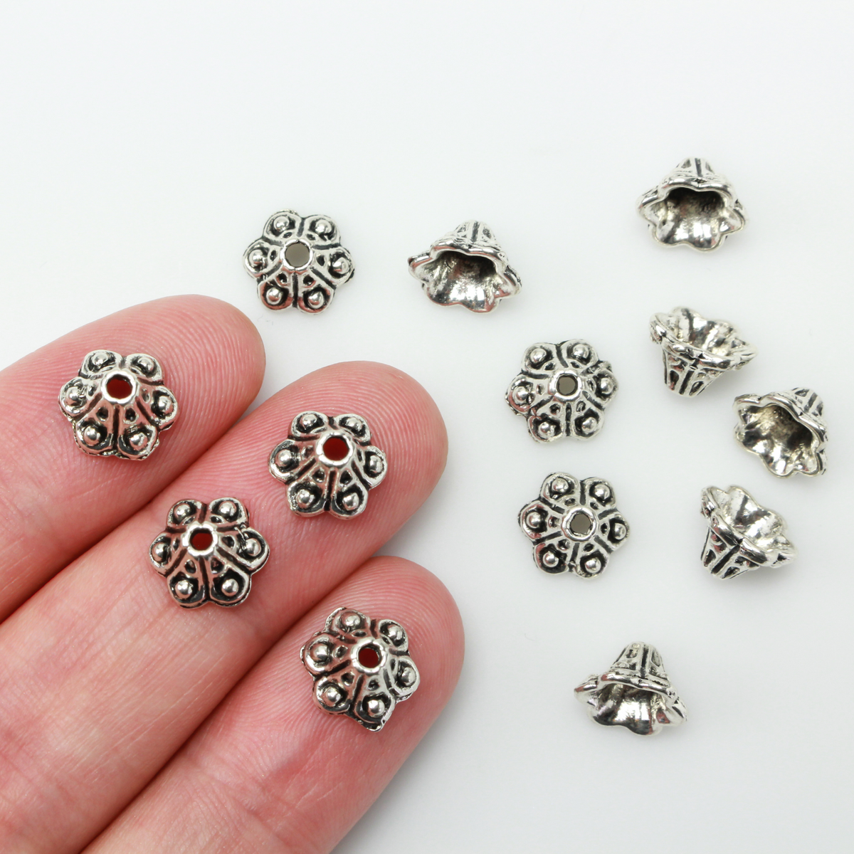 Bell flower shaped bead caps that will fit beads 8mm - 10mm. Shown on an 8mm glass bead for size reference. Sold in packages of 50 caps