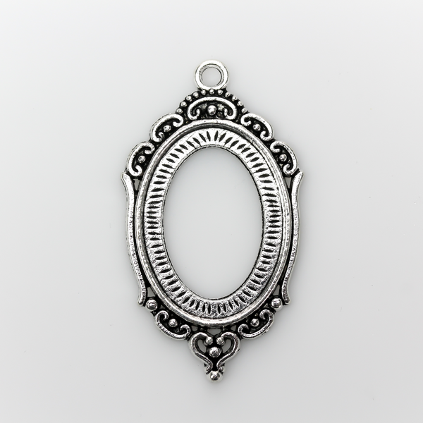 Ornate oval antiqued silver style cabochon setting with an open back