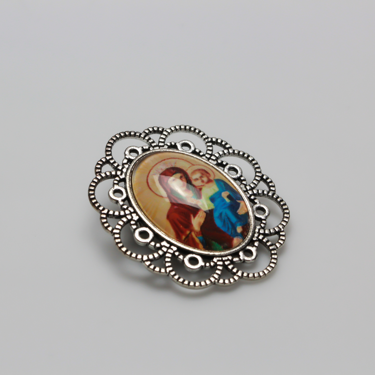 Silver tone oval bezel brooch pin with an ornate filigree border. The tray size on this bezel is 25mm x 18mm