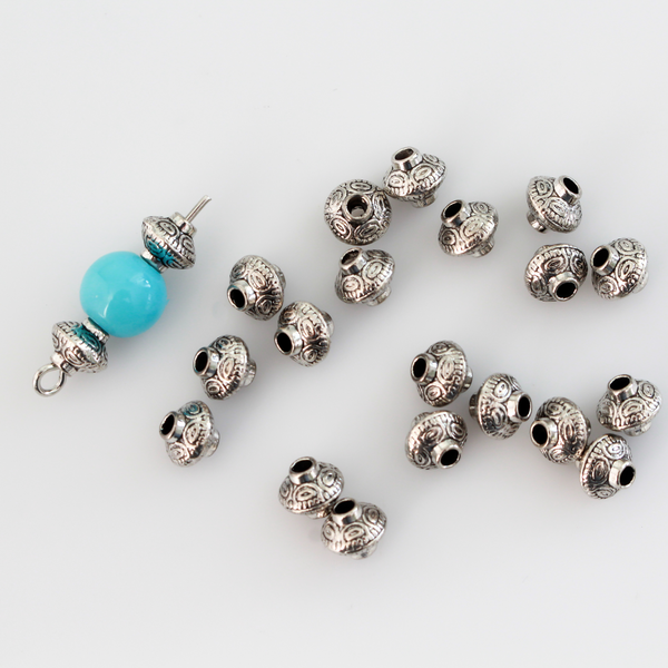 50 metal bicone shaped spacer beads with an antiqued silver finish and a carved dot pattern