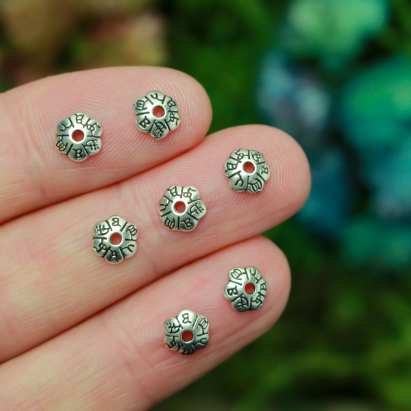 Flower shaped zinc alloy antiqued silver bead caps that are 6mm in diameter