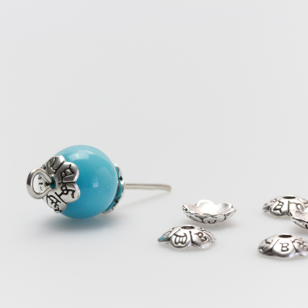 Flower shaped zinc alloy antiqued silver bead caps that are 6mm in diameter