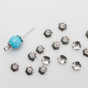 Flower shaped zinc alloy antiqued silver bead caps that are 6mm in diameter